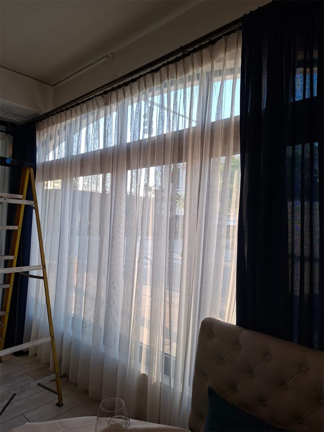 Sheer curtains being cleaned on site in a Miami home